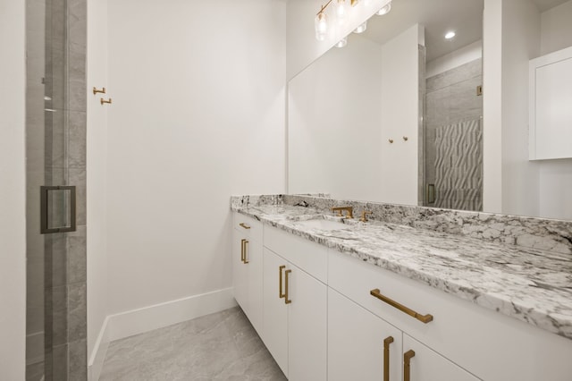 bathroom with vanity and a shower with shower door