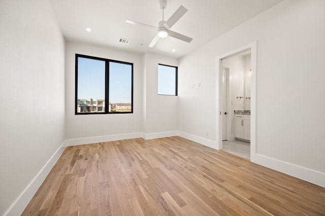 spare room with ceiling fan and light hardwood / wood-style flooring