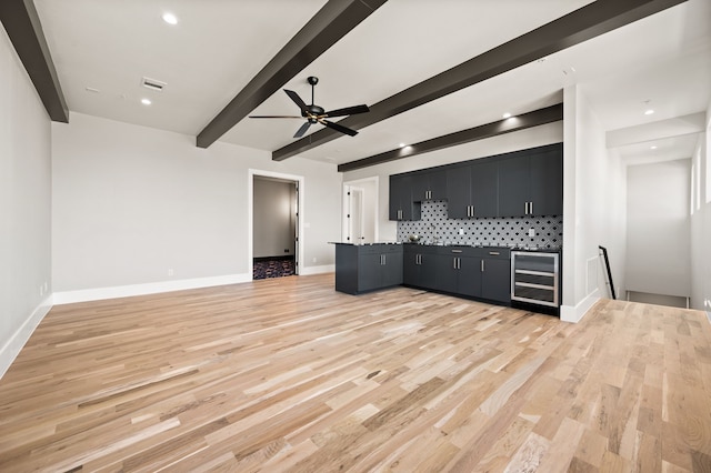 interior space featuring indoor bar, beverage cooler, ceiling fan, light hardwood / wood-style floors, and beam ceiling