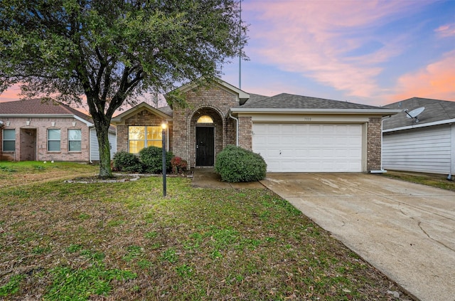 ranch-style home with a yard and a garage