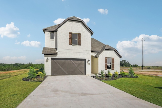 view of property with a garage and a front lawn