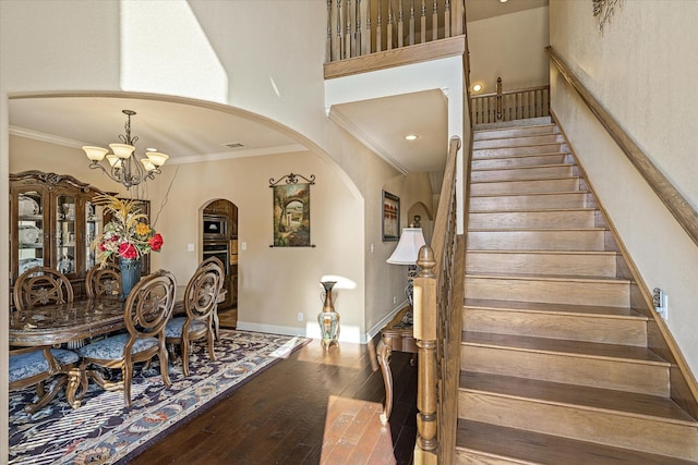 597 Imagine Dr, Lindale, TX 75771 - dining space featuring an inviting chandelier, a towering ceiling, ornamental molding, and hardwood / wood-style floors