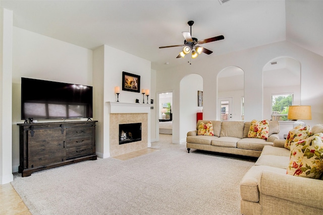 carpeted living room featuring ceiling fan, a fireplace, and high vaulted ceiling