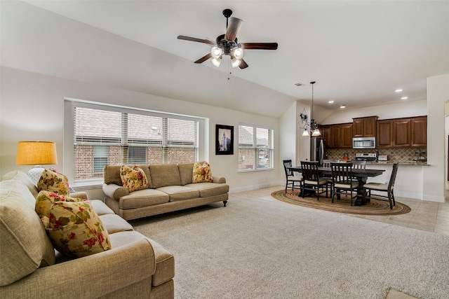 carpeted living room featuring lofted ceiling and ceiling fan