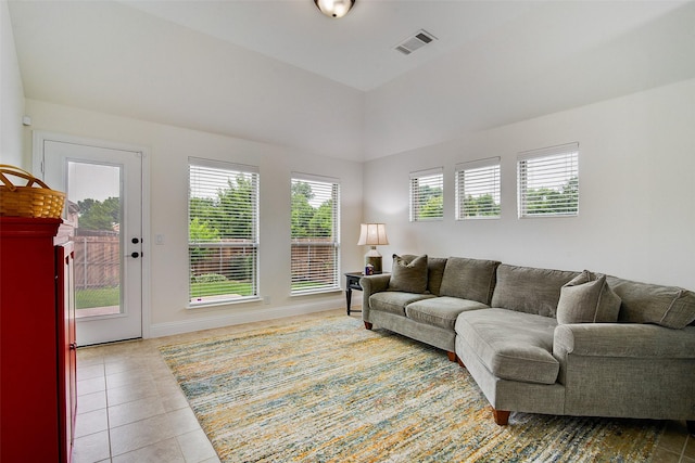 tiled living room with vaulted ceiling