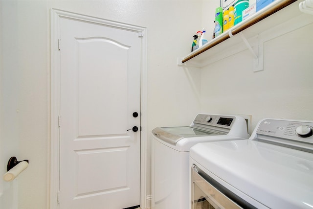 washroom with washing machine and clothes dryer