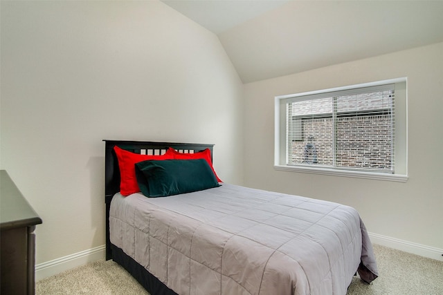 bedroom with light carpet and vaulted ceiling