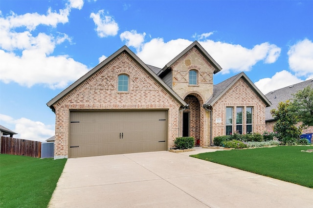 view of front of house featuring a garage and a front lawn