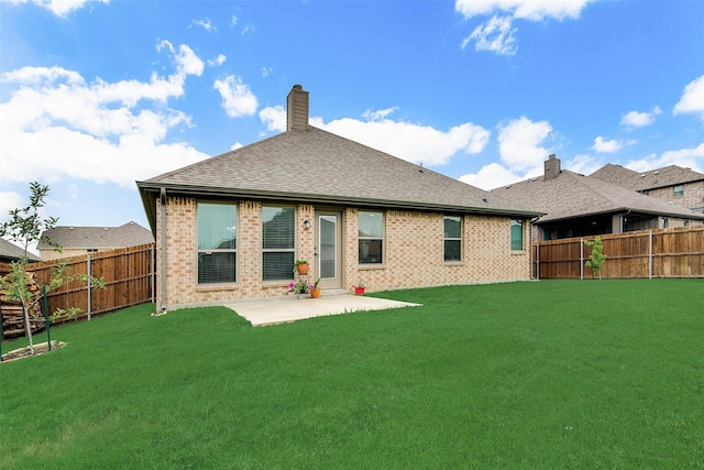 back of house featuring a yard and a patio area