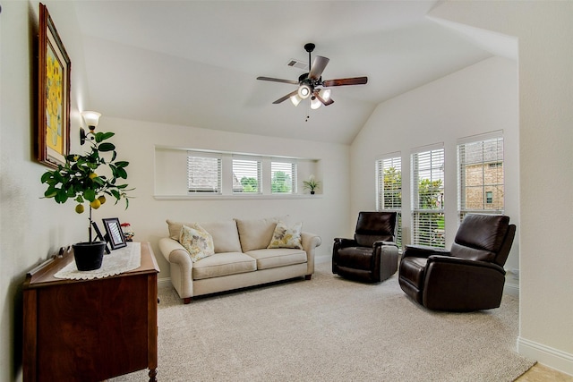 carpeted living room with ceiling fan and lofted ceiling