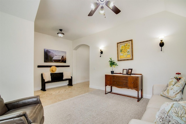 carpeted living room with ceiling fan