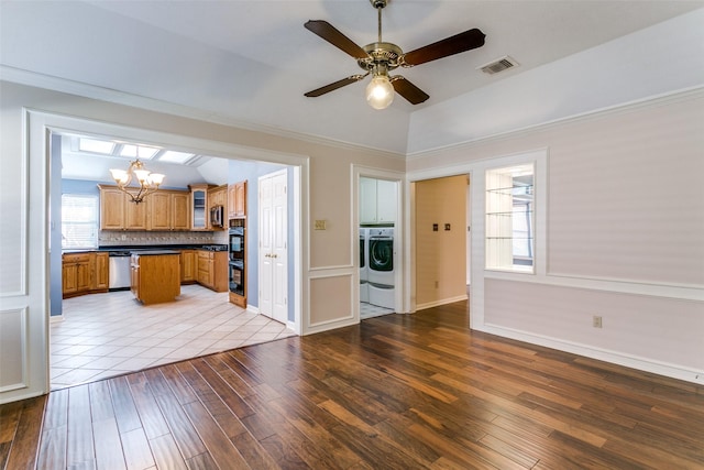 kitchen with crown molding, light hardwood / wood-style flooring, stainless steel appliances, tasteful backsplash, and washer / clothes dryer