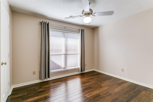 empty room with dark hardwood / wood-style floors and ceiling fan