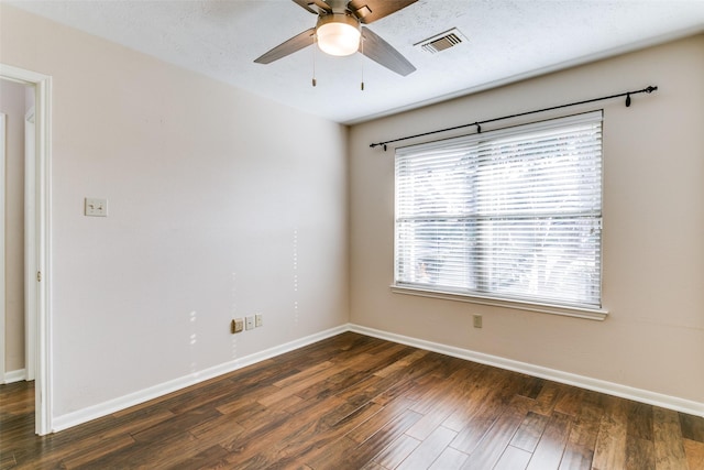 empty room featuring dark wood-type flooring, ceiling fan, and a textured ceiling