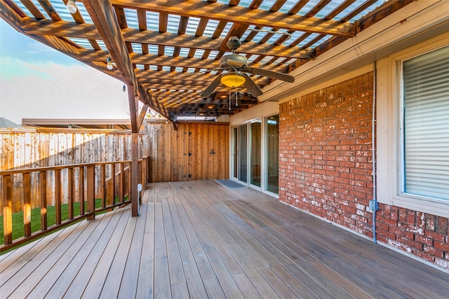 deck featuring ceiling fan and a pergola