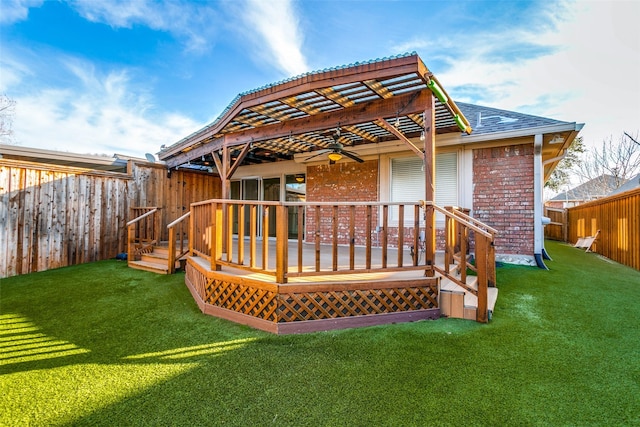 back of house with ceiling fan, a yard, and a deck