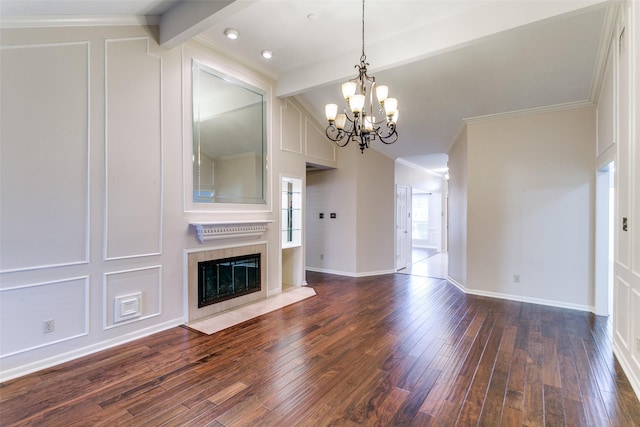 unfurnished living room featuring a tile fireplace, vaulted ceiling with beams, dark hardwood / wood-style flooring, ornamental molding, and a notable chandelier