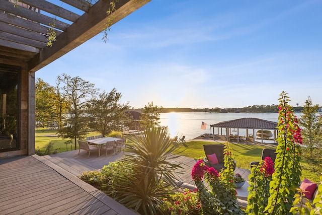 view of dock with a gazebo, a deck with water view, a yard, and a pergola