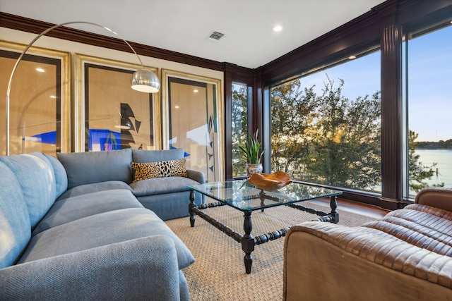 sunroom featuring a water view and a healthy amount of sunlight