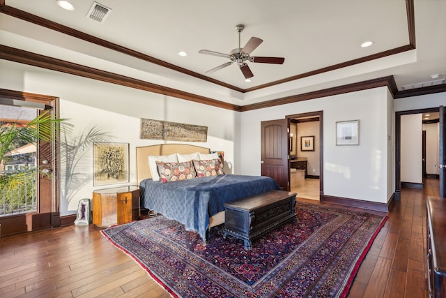 bedroom with a tray ceiling, wood-type flooring, ornamental molding, and ceiling fan