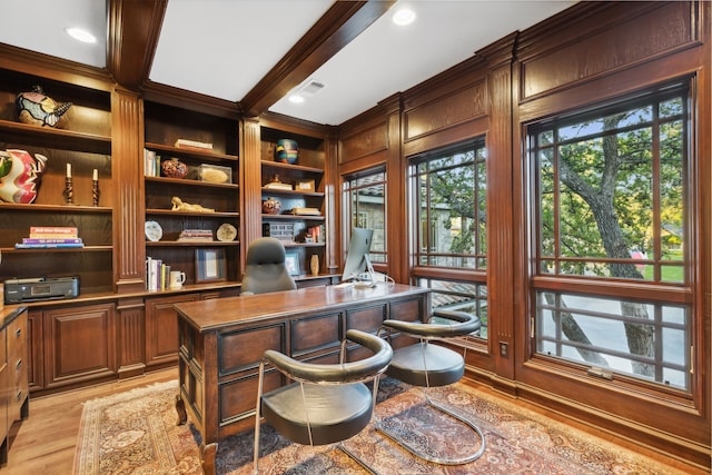 home office featuring beamed ceiling and light wood-type flooring