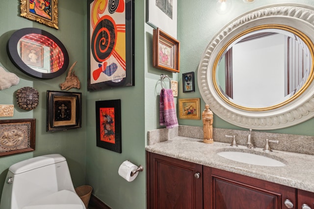 bathroom featuring vanity and toilet