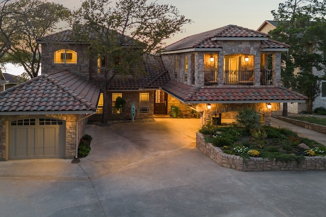 mediterranean / spanish-style house with a balcony and a garage