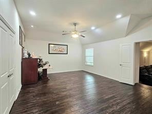 living room featuring dark wood-type flooring, ceiling fan, and lofted ceiling