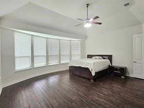 bedroom with ceiling fan, dark hardwood / wood-style floors, and vaulted ceiling