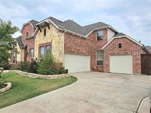 view of front of home with a garage and a front lawn