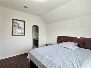 bedroom featuring lofted ceiling and dark hardwood / wood-style flooring