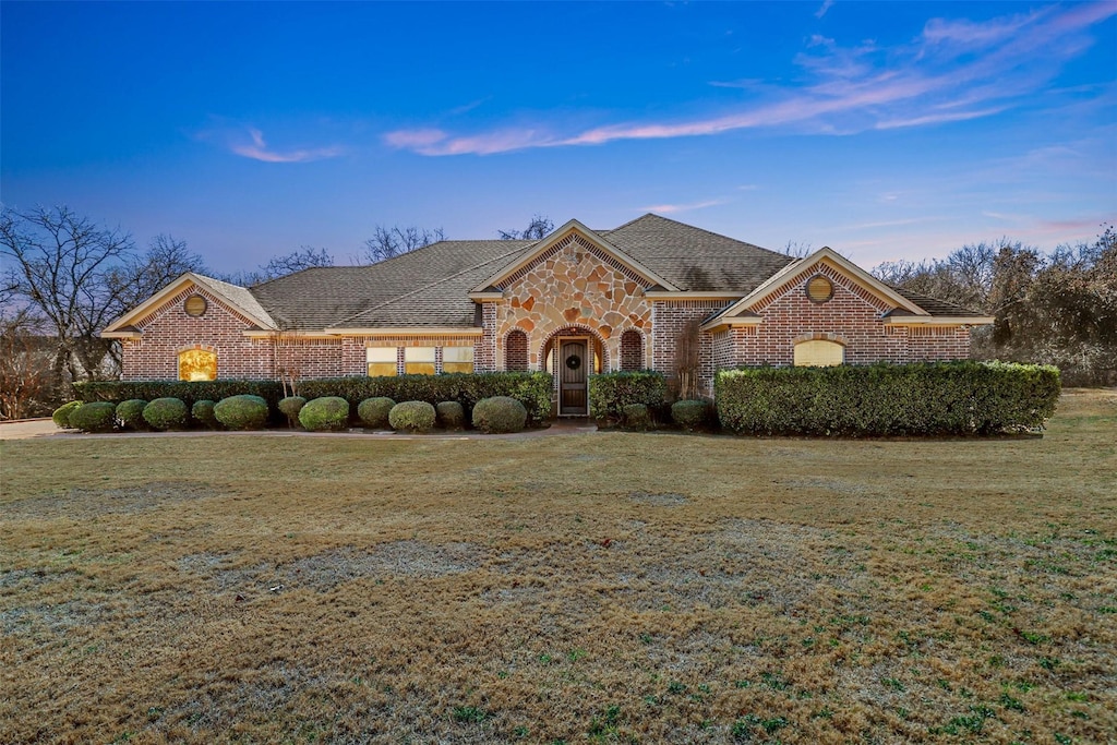 view of front of home with a yard