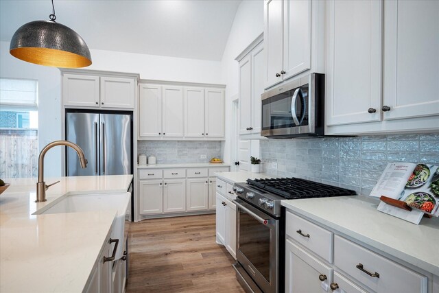3512 Pritchard Rd, Celina, TX 75009 - kitchen featuring stainless steel appliances, a sink, light countertops, pendant lighting, and lofted ceiling