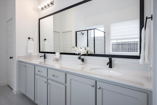 bathroom with vanity, tile patterned flooring, and a shower with door