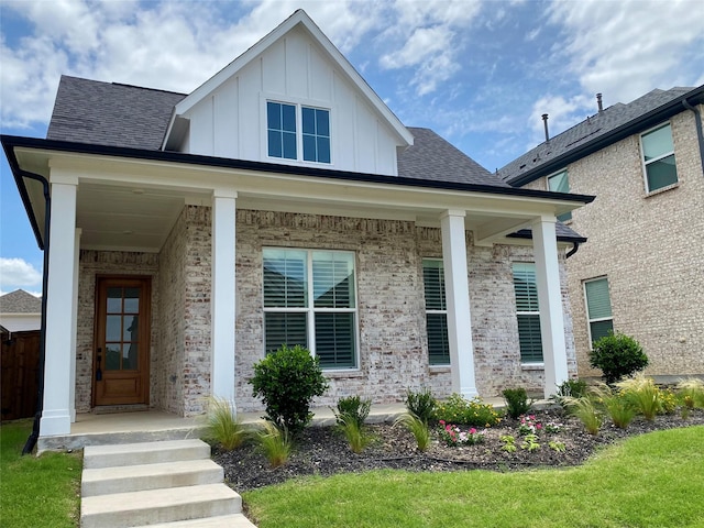 3512 Pritchard Rd, Celina, TX 75009 - view of front of home with board and batten siding, brick siding, a porch, and a shingled roof