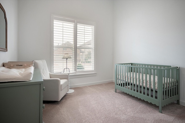 bedroom with light carpet and a crib