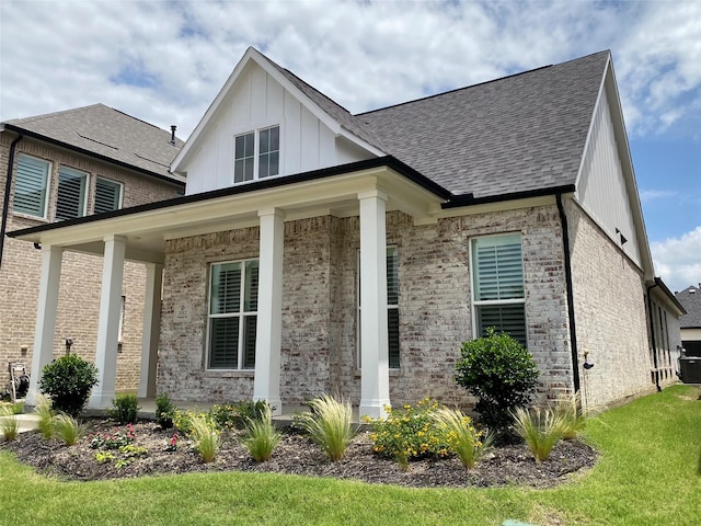 3512 Pritchard Rd, Celina, TX 75009 - view of front of property with brick siding, roof with shingles, board and batten siding, a porch, and central air condition unit