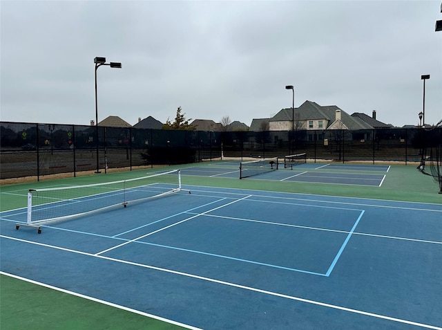 view of tennis court with basketball hoop