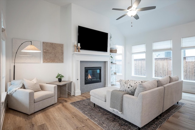 living room with lofted ceiling, hardwood / wood-style floors, and ceiling fan