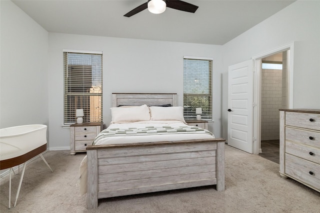 carpeted bedroom with connected bathroom and ceiling fan