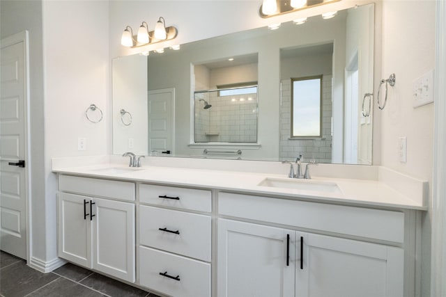 bathroom featuring tile patterned floors, vanity, and a tile shower