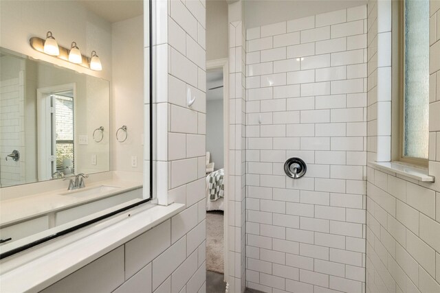 bathroom with vanity and tiled shower