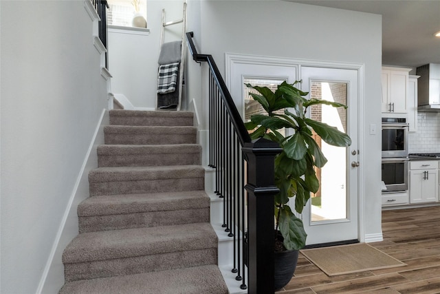 staircase with wood-type flooring