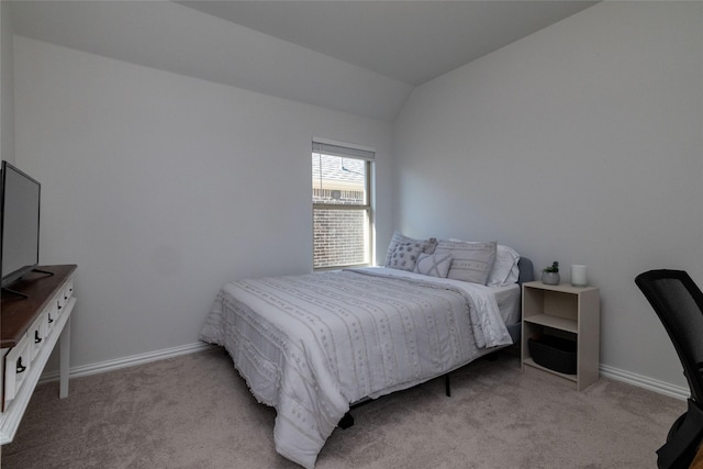 bedroom with light colored carpet and vaulted ceiling