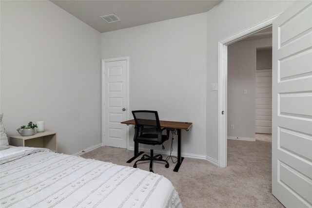 bedroom featuring light colored carpet