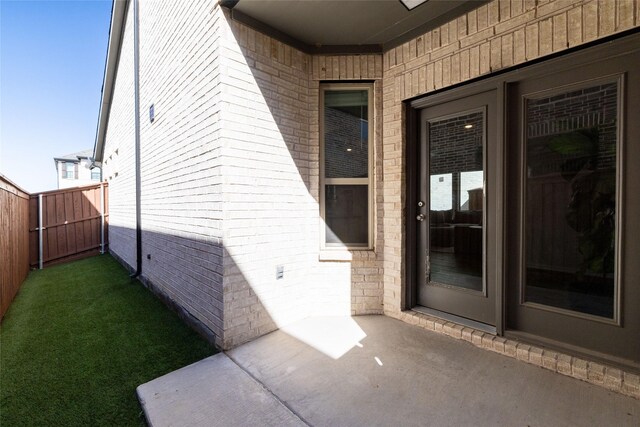 view of exterior entry featuring a patio