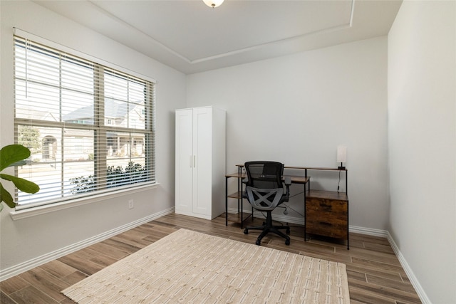 home office with wood finished floors and baseboards