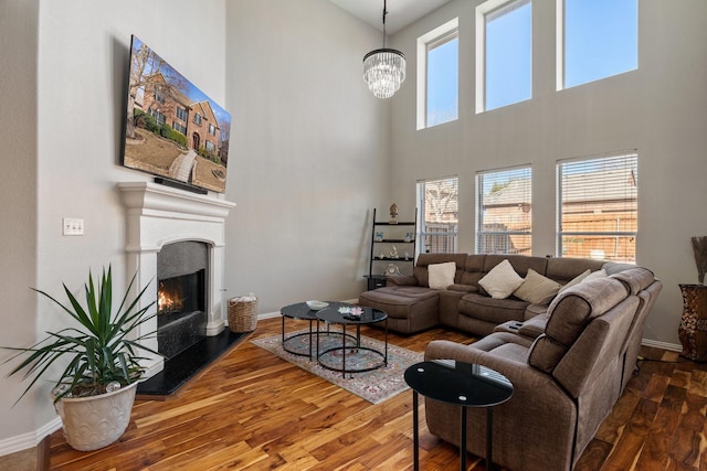 living room with hardwood / wood-style flooring and a notable chandelier