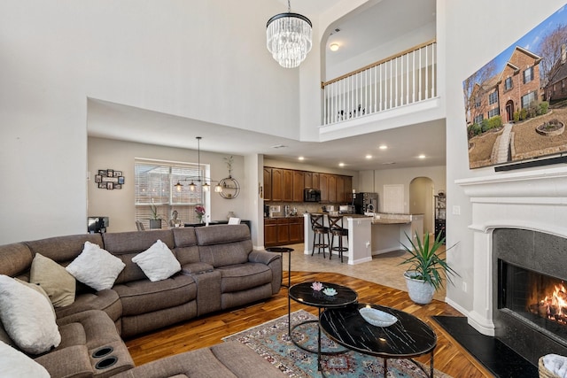 living room featuring a notable chandelier and light hardwood / wood-style flooring