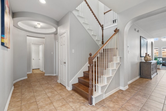 stairway with tile patterned floors